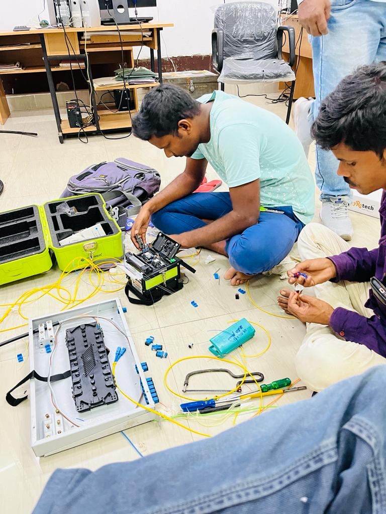 Technicians fusion-splicing optical fiber on site
